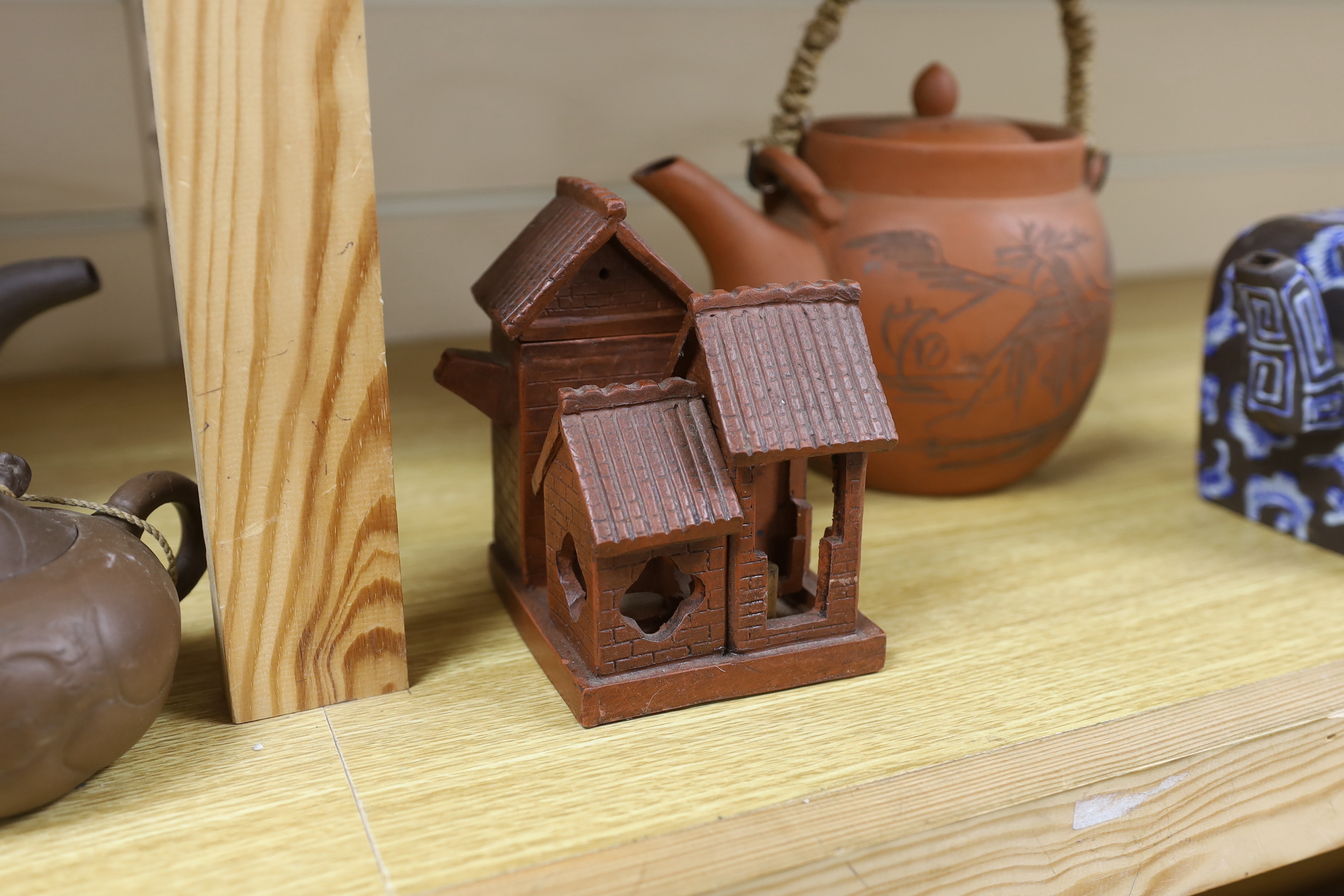A quantity of Chinese Yixing teapots and terracotta tea bowls, the largest 20cm wide